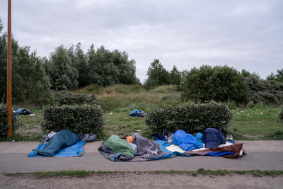 Des personnes exilées, privées de leur tente par les forces de police, dorment à même le sol, à Calais (Pas-de-Calais), le 16 juillet 2021. SAMUEL GRATACAP POUR « LE MONDE »