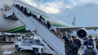 - AFP | Des migrants irakiens entrent dans un avion pour retourner en Irak, à l'aéroport de Minsk, en Biélorussie, le 18 novembre 2021.