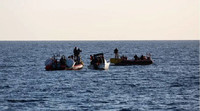 Des migrants secourus par une équipe de l'association SOS Mediterranée, le 18 mars 2021, près des côtés en Libye. (JEREMIE LUSSEAU / HANS LUCAS / AFP)