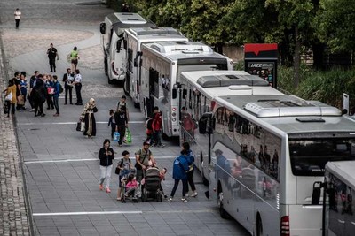 Cinq bus ont été utilisés pour mettre les 157 migrants du camp « à l’abri », pour un mois. MARTIN BUREAU / AFP